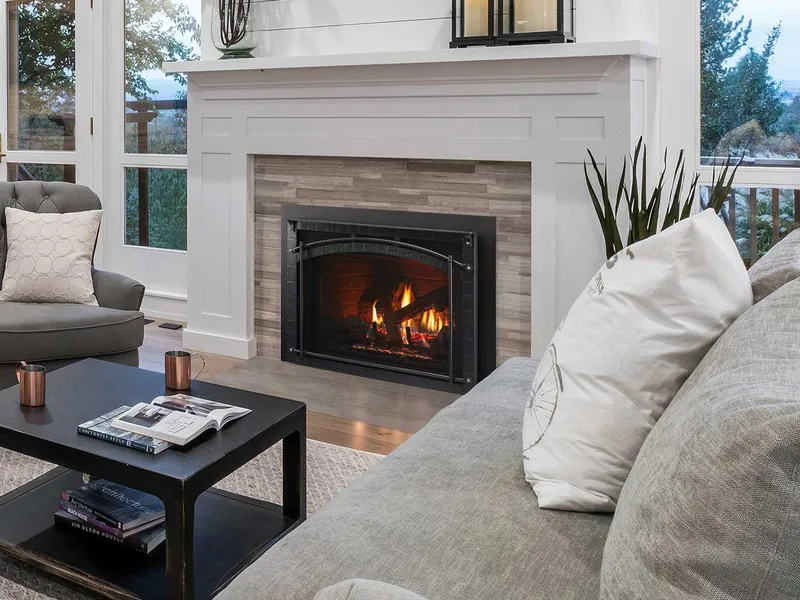 Heat & Glo Escape gas fireplace insert installed in an existing masonry firebox with custom tile surround