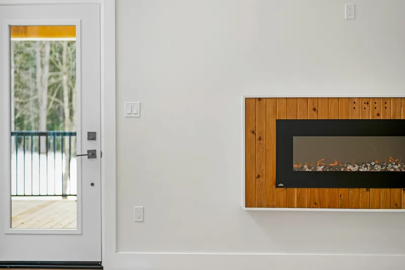 Modern direct vent linear gas fireplace installed flush in a living room wall