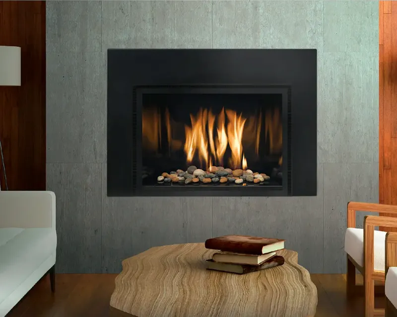 Mendota gas fireplace insert with tall flames and river rock media bed installed in a modern concrete-surround living room